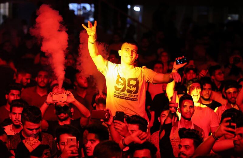 Youths attend an electronic dance music event, during the annual Baghdad Summer Festival at the People's Hall in the Iraqi capita.  AFP