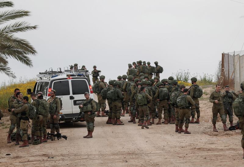 Israeli soldiers make their way to their positions at the Israeli border with Gaza next to the security fence on March 29, 2019. EPA