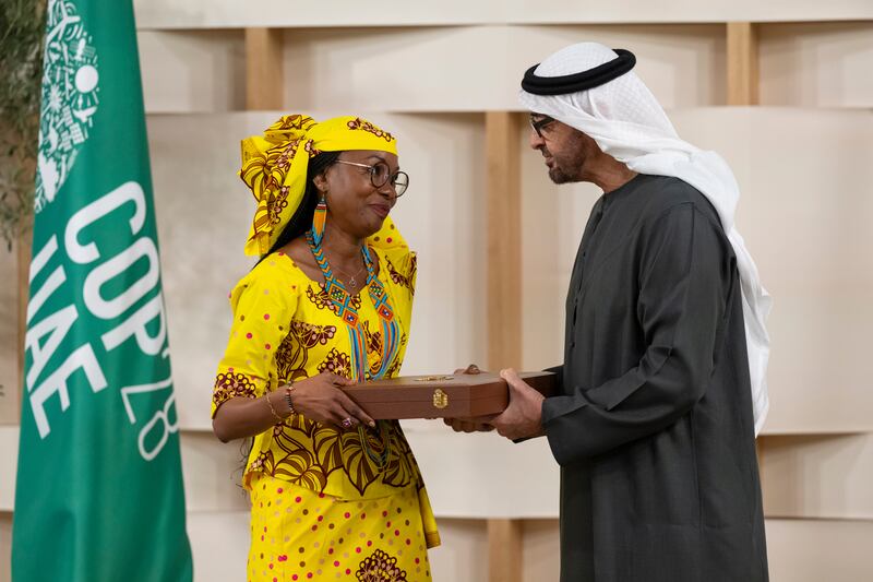 Sheikh Mohamed presents the First Class Order of Zayed II medal to Hindou Ibrahim, from the Association for Indigenous Women and Peoples of Chad. Abdulla Al Neyadi / Presidential Court