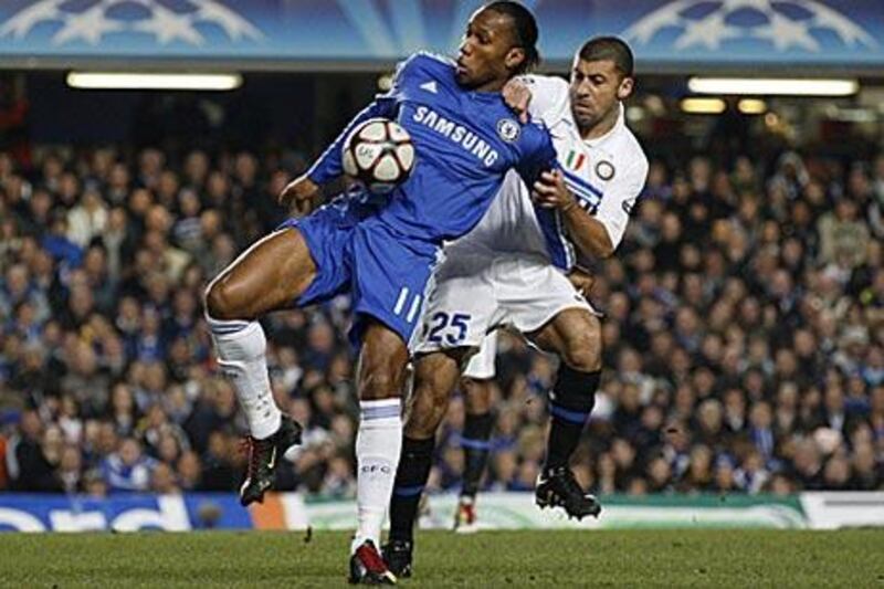Chelsea's Didier Drogba, left, competes with Inter Milan's Walter Samuel in their Champions League match at Stamford Bridge.