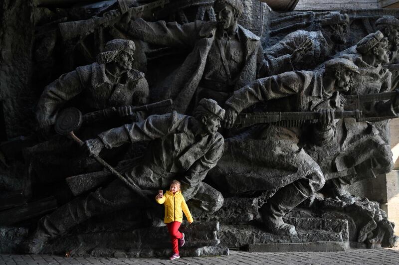 A girl takes a selfie in front of a sculptural composition at the WWII open air museum in Kiev. Ukraine marks the 75th anniversary of the country's liberation from the Nazis. AFP