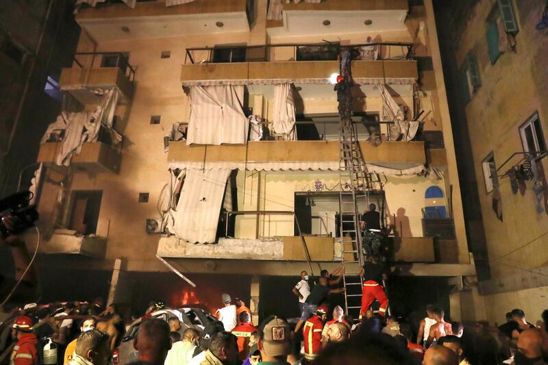 Residents are rescued from  the upper floors after the blast. AP