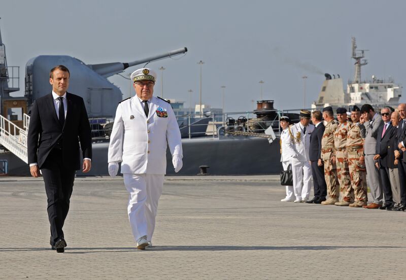 French president Emmanuel Macron walks at a naval base in Abu Dhabi after visiting French warship Jean Bart. Ludovic Marin / AFP