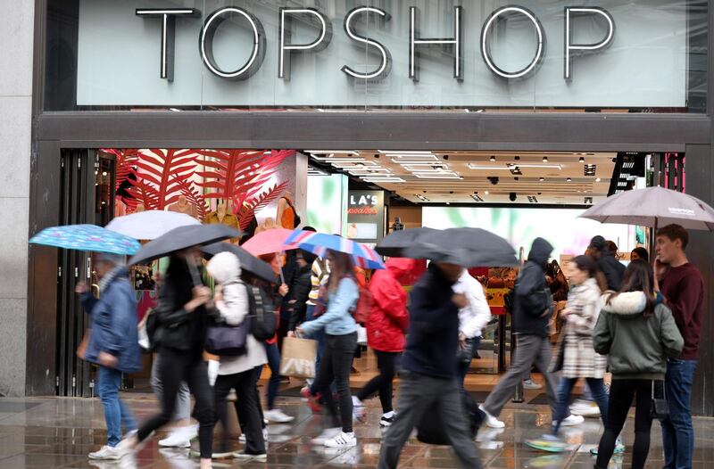 (FILES) In this file photo taken on June 12, 2019 pedestrians and shoppers walk past a Topshop and Topman store, operated by Arcadia, in London. The British ready-to-wear group Arcadia, known for its Topshop brand, filed for bankruptcy on Monday, November 30, swept away by a drop in activity due to the health crisis, announced the firm Deloitte. / AFP / ISABEL INFANTES
