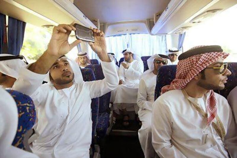 Ali Al Falahi, left, a Emirati ambassador, takes part in a training tour of Abu Dhabi. Sammy Dallal / The National