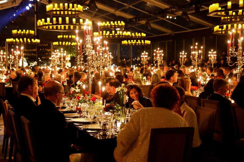 Guests dined in heated tents amid candle-style lighting on the South Lawn. Reuters