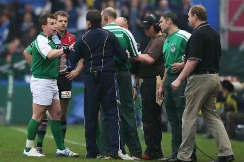 Nick Evans, second from left, of Harlequins, is brought back on to the field to replace the injured Tom Williams as referee Nigel Owens talks to Harlequins coach Dean Richards, right, and Leinster officials during the Heineken Cup quarter-final match between at the Stoop on April 12, 2009 in Twickenham, England. Williams was later found to use a blood capsule to fake the injury on the order of Richards.