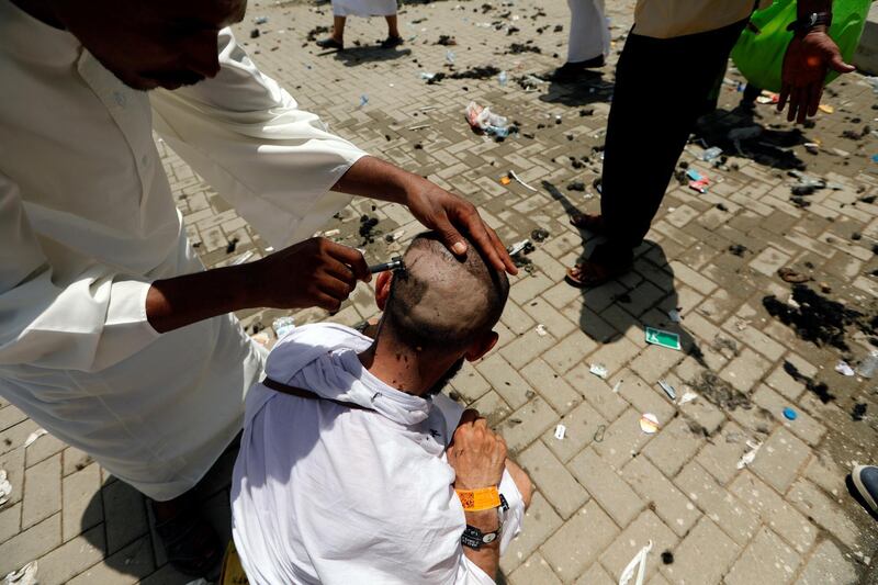 A muslim pilgrim has his head shaved after casting seven stones at a pillar that symbolizes Satan which  is part of the annual haj pilgrimage rite in Mena, Saudi Arabia August 21, 2018. REUTERS/Zohra Bensemra