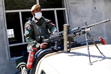 An Afghan soldier mans a machinegun at a checkpoint on the outskirts of Kabul. Reuters