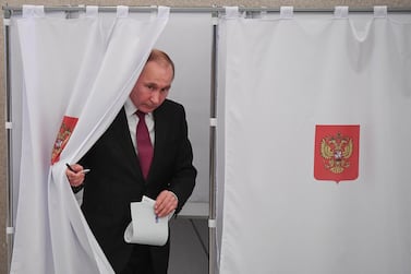 President Vladimir Putin walks out of a voting booth. AFP