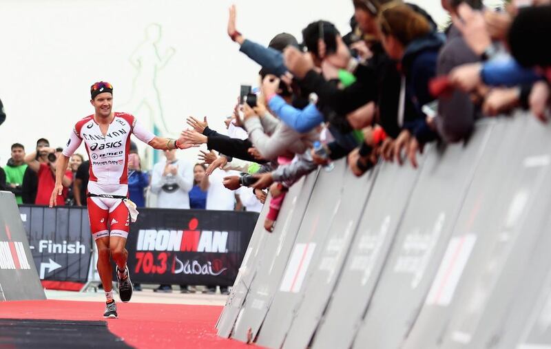 DUBAI, UNITED ARAB EMIRATES - JANUARY 29:  Jan Frodeno of Germany acknowledges the crowd as he wins the Men's IRONMAN 70.3 Dubai on January 29, 2016 in Dubai, United Arab Emirates.  (Photo by Warren Little/Getty Images for Ironman)