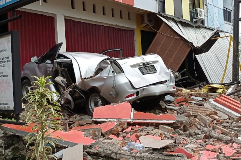 A damaged car and buildings are seen following an earthquake in Mamuju. Reuters