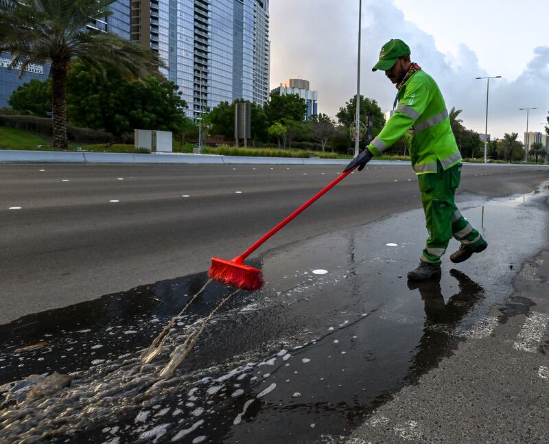 A street cleaner at work on Friday morning in central Abu Dhabi. Victor Besa / The National