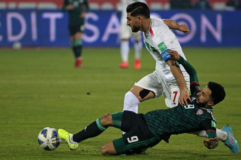 UAE's Bandar al-Ahbabi tackles Alireza Bakhsh of Iran. AFP