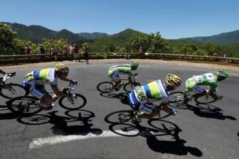 The pack of riders cycles its way past a curve on the seventh stage. Jean-Paul Pelissier / Reuters