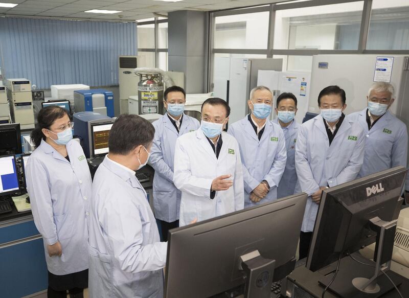 A picture released by Xinhua News Agency shows Chinese Premier Li Keqiang (C), also a member of the Standing Committee of the Political Bureau of the Communist Party of China (CPC) Central Committee and head of the leading group of the CPC Central Committee on the prevention and control of the epidemic, inspecting the Institute of Pathogen Biology at the Chinese Academy of Medical Sciences in Beijing, China.  EPA