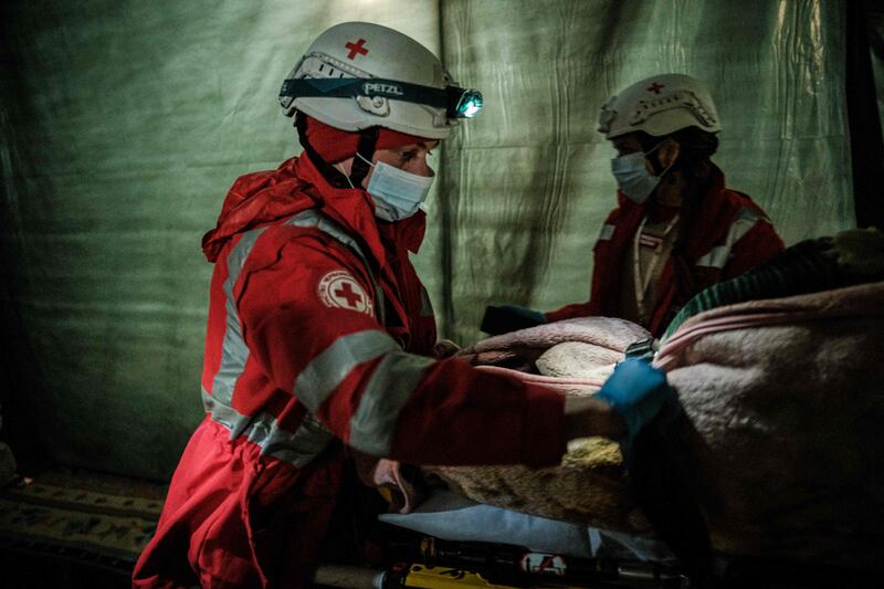 Members of the Ukrainian Red Cross carry an internally displaced 92-year-old woman to an ambulance in a bunker at a factory in Severodonetsk, eastern Ukraine. AFP