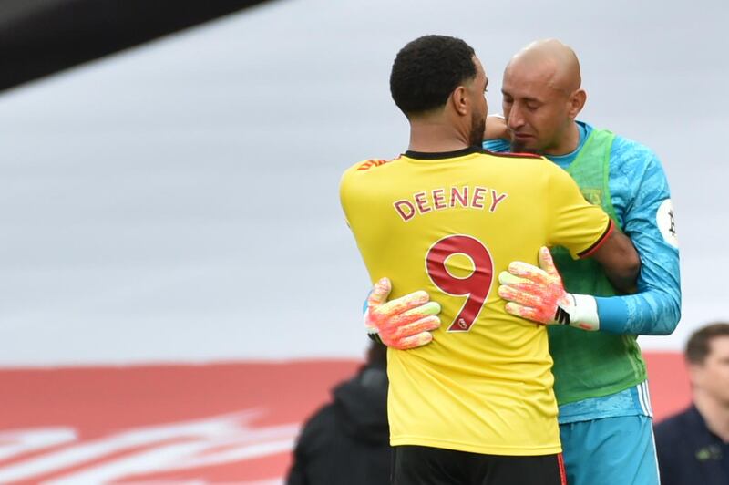 Watford captain Troy Deeney (L) embraces goalkeeper Heurelho Gomes after the club's relegation from the Premier League. AFP