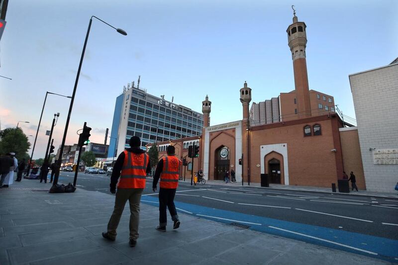 Two muslim security volunteers on patrol at dusk outside the East London Mosque in Whitechapel, East London on June 11, 2013. Stephen Lock for The National 