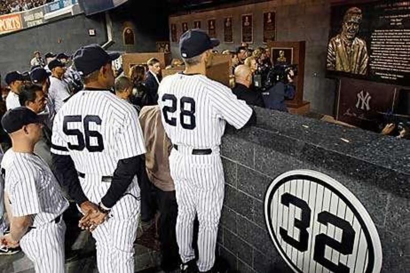 New York Yankees manager Joe Girardi, No 28, admires the monument to George Steinbrenner in Monument Park.