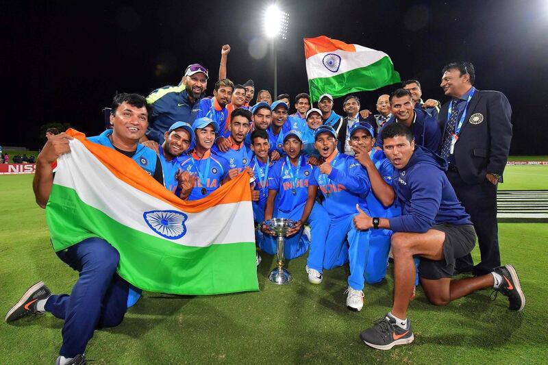 India's team poses as they celebrate their victory in the U19 cricket World Cup final match between India and Australia at Bay Oval in Mount Maunganui on February 3, 2018. / AFP PHOTO / Marty MELVILLE