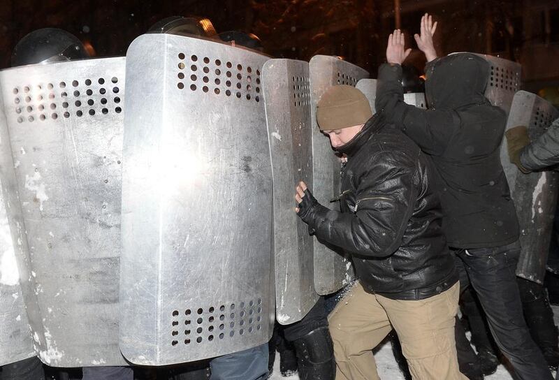 Protesters try to defend a barricade blocking the government building district from riot police in Kiev. Valentina Svistunova / EPA