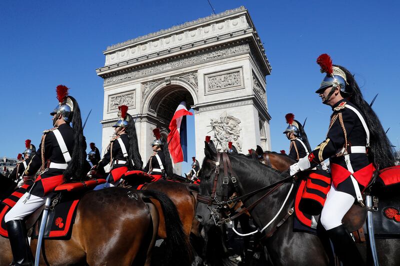 
                  French Republican Guards ride their horse pas the Arc de Triomphe in Paris, Friday, July 14, 2017. Paris has tightened security before its annual Bastille Day parade, which this year is being opened by American troops with President Donald Trump as the guest of honor to commemorate the 100th anniversary of the United States' entry into World War I. (Etienne Laurent, Pool via AP)
               