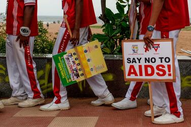 School children hold placards in an awareness event on the eve of the 'World AIDS Day' in Chennai on Saturday. Arun Sankar / AFP