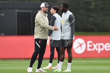 KIRKBY, ENGLAND - SEPTEMBER 14: Jurgen Klopp, Manager of Liverpool speaks to Ibrahima Konate of Liverpool during a training session ahead of their UEFA Champions League group stage match against AC Milan at AXA Training Centre on September 14, 2021 in Kirkby, England. (Photo by Nathan Stirk / Getty Images)
