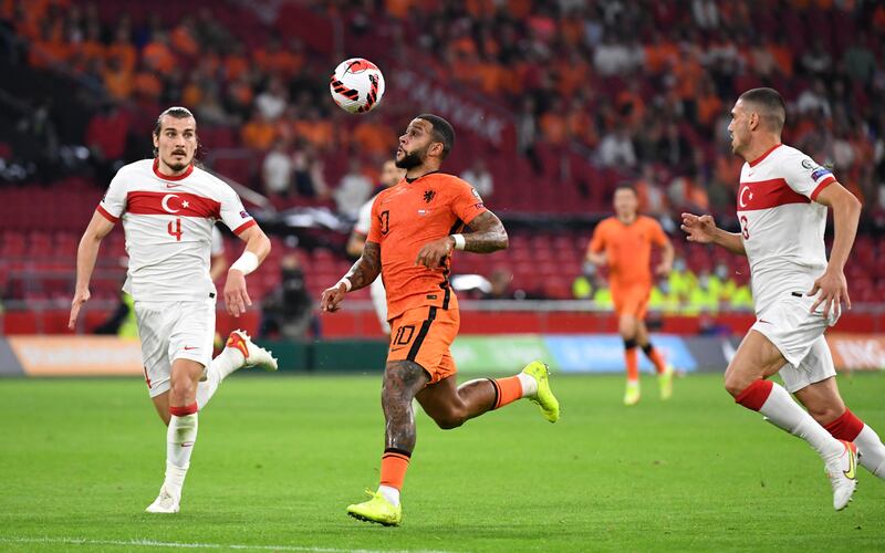 Netherlands' Memphis Depay in action with Turkey's Caglar Soyuncu. Reuters