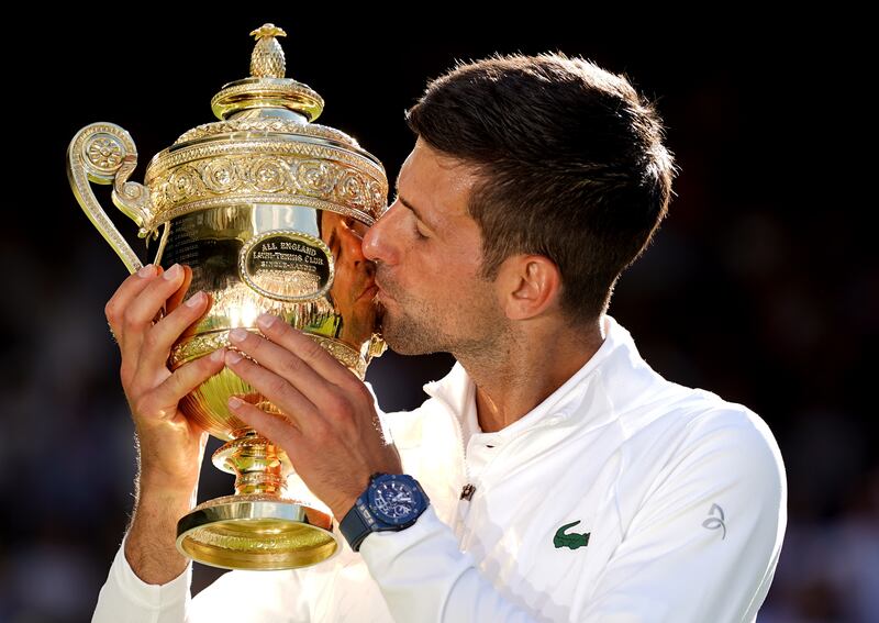 Novak Djokovic kisses the trophy after beating Nick Kyrgios in the Wimbledon final at the All England Club, on July 10, 2022. PA