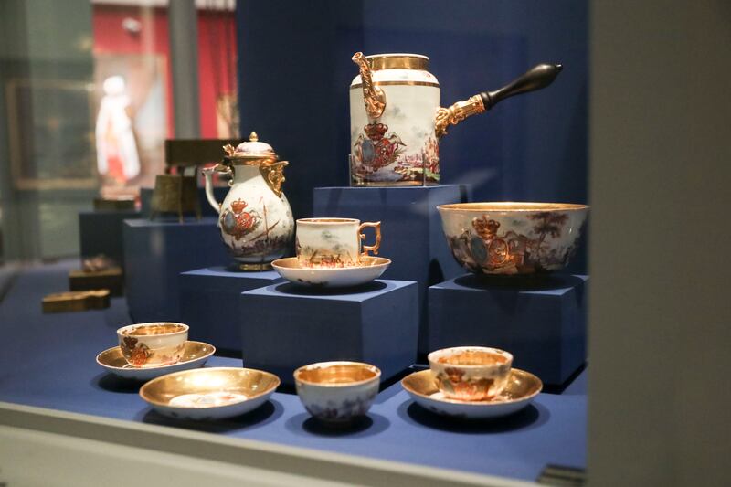 Tea and chocolate service of Marie Leszczynska: a large rinsing bowl, three tea bowls with saucer, two chocolate cups with saucers, chocolate pot and milk jug, made of hard-paste porcelain, blackened wood and gilt silver, on display at the exhibition.