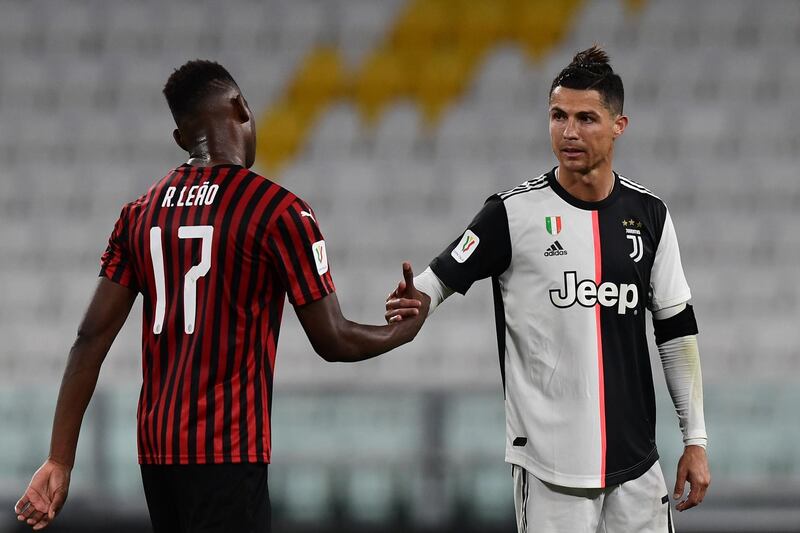 Ronaldo taps hand with AC Milan's Portuguese forward Rafael Leao. AFP