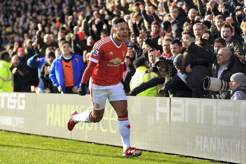 WATFORD, ENGLAND - NOVEMBER 21: Memphis Depay of Manchester United celebrates scoring his team's first goal during the Barclays Premier League match between Watford and Manchester United at Vicarage Road on November 21, 2015 in Watford, England.  (Photo by Stephen Pond/Getty Images)