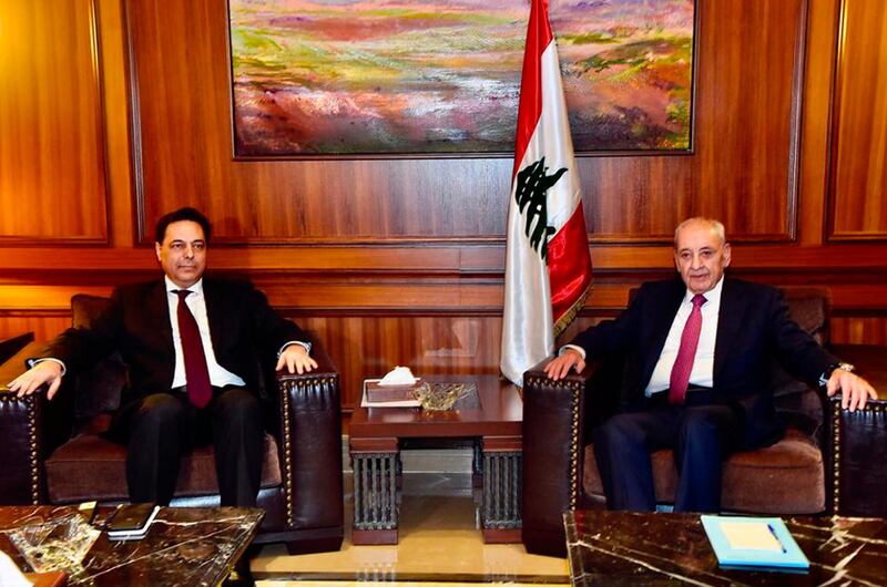 In this photo released by Lebanon's official government photographer Dalati Nohra, Parliament Speaker Nabih Berri, right, meets with newly-assigned Lebanese Prime Minister, Hassan Diab, in Beirut, Lebanon, Saturday, Dec. 21, 2019. Diab said he plans to form a government of experts and independents to deal with the country's crippling economic crisis. Diab spoke to reporters Friday, following a meeting with former Prime Minister Saad Hariri, a day after he was asked by the president to form the country's next government. (Dalati Nohra via AP)