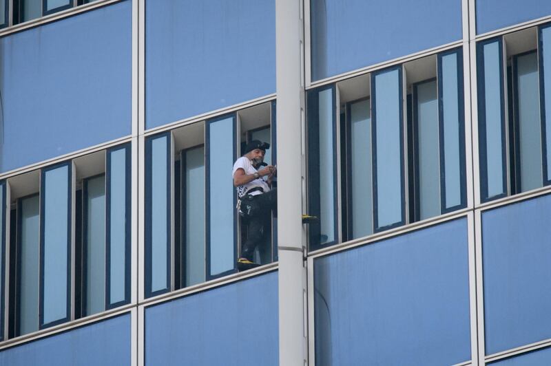 Robert, who holds a world record for urban climbing, surrendered to a "cat and mouse" chase. Ed Jones / AFP