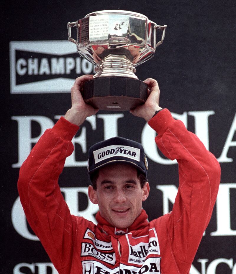 FILE PHOTO: Ayrton Senna of Brazil raises his trophy after winning the Belgian Grand Prix August 28, 1988. SCANNED FROM NEGATIVE. REUTERS/Frederique Lengaigne/File Photo PLEASE SEARCH "FROM THE FILES - 25TH ANNIVERSARY OF AYRTON SENNA'S DEATH" FOR ALL PICTURES