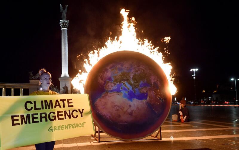 The Earth on fire is seen during a Greenpeace protest at the Heroes square in Budapest.  AFP