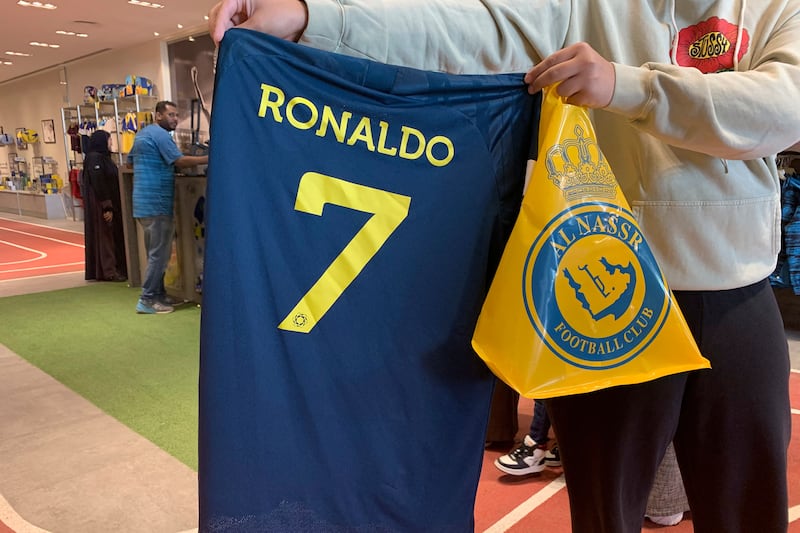 A fan holds a Cristiano Ronaldo jersey at the Al Nassr club store in Riyadh. AFP