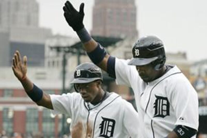 Detroit Tigers' Marcus Thames, right, celebrates his first two-run home run with teammate Curtis Granderson in the first inning of their match with the Milwaukee Brewers on Friday, which Detroit won 10-4.