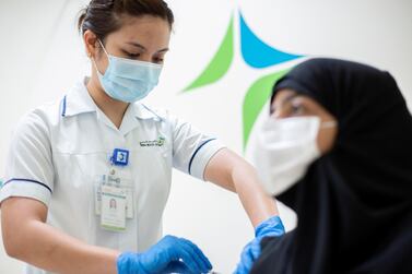A woman receives a Covid-19 vaccination in Dubai. EPA