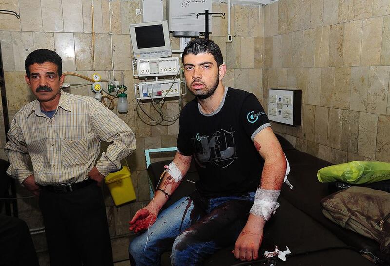 An injured Syrian man receiving first aid at a hospital in Damascus on April 13. According to SANA, two mortar shells landed in Damascus' Beirut Street and hit a bus, which allegedly led to the death of a girl and the injuring of 22 people.  EPA/SANA