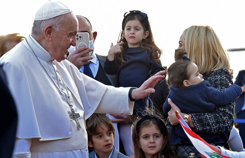 Pope Francis greets people upon his arrival in Larnaca. AFP