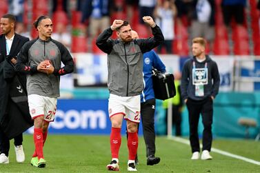 Denmark's Pierre-Emile Hojbjerg gestures to the stands as the team returns to the pitch to resume the match against Finland suspended when Christian Eriksen collapsed. AP