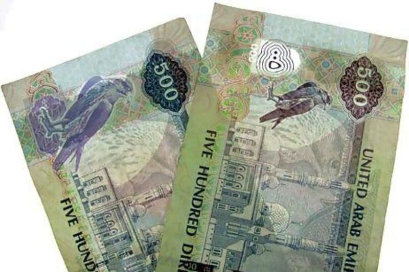 A new 500 dirham note, right, next to an old one. The banknotes have been upgraded with new security features.The National staff