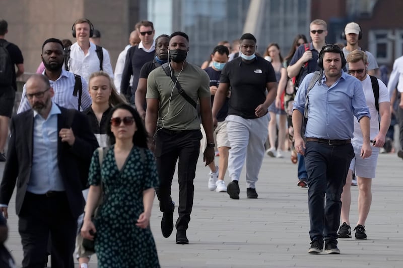 On what some have called 'Freedom Day', marking the end of coronavirus restrictions in England, people walk over London Bridge during the morning rush hour.