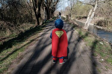 A child dressed in a Superman outfit walks down a street in Casalpusterlengo, one of the Italian towns on lockdown due to a coronavirus outbreak. Reuters