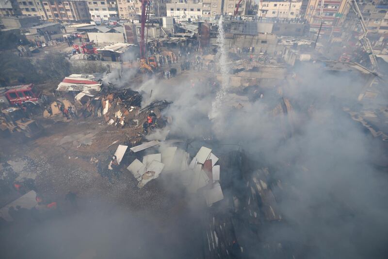 Palestinian firefighters work at the scene where the fire broke out. Reuters