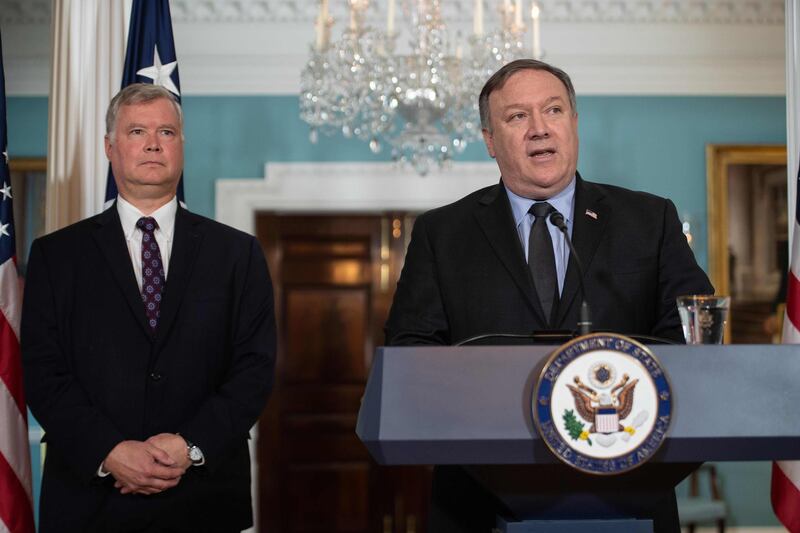 (FILES) In this file photo taken on August 23, 2018, US Secretary of State Mike Pompeo announces Steve Biegun (L) as special representative to North Korea at the State Department in Washington, DC. - US President Donald Trump on Auguat 24, 2018, announced the cancellation of his top diplomat's upcoming visit to North Korea, while taking a swipe at China over efforts to disarm the nuclear state. "I have asked Secretary of State Mike Pompeo not to go to North Korea, at this time, because I feel we are not making sufficient progress with respect to the denuclearization of the Korean Peninsula," Trump said by tweet. (Photo by NICHOLAS KAMM / AFP)