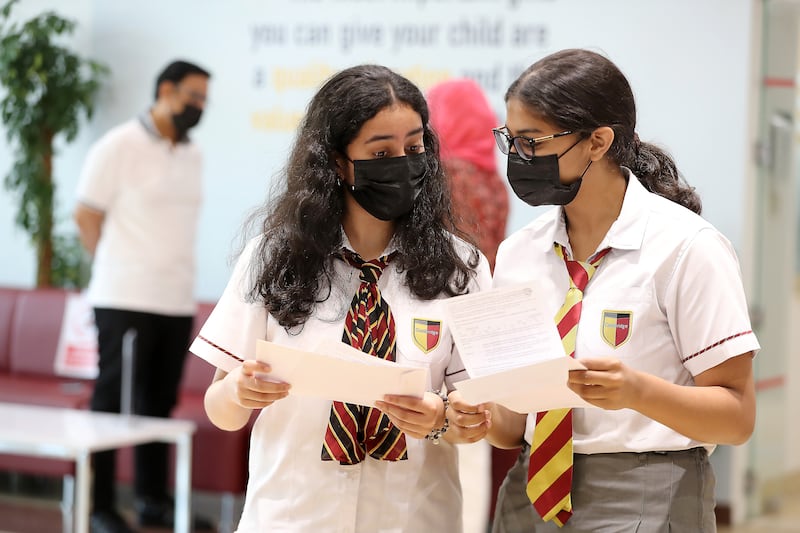 Greeshma Giridas, left, and Erin Isabel look over their A-level results at Cambridge  International School in Dubai. Pawan Singh / The National